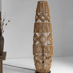 Tall lamp with a tightly hand woven brown wicker shade on a wood and iron stand