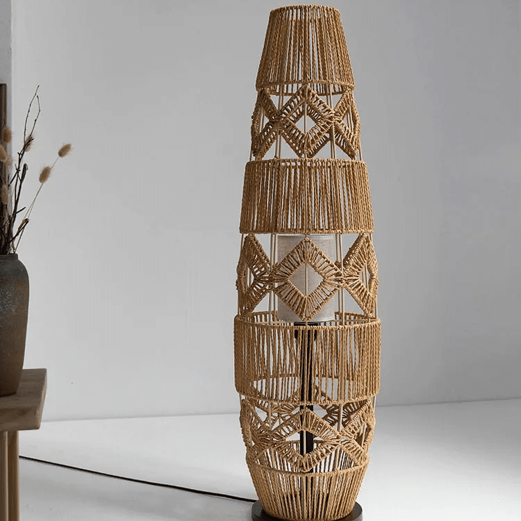 Tall lamp with a tightly hand woven brown wicker shade on a wood and iron stand