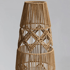 Tall lamp with a tightly hand woven brown wicker shade on a wood and iron stand