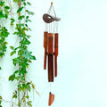 Brown bamboo wind chime with a coconut shell top and bamboo tubes