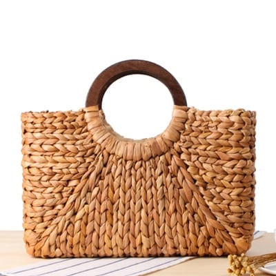 Structured hand woven rattan beach bag with a sturdy handle and outer pockets