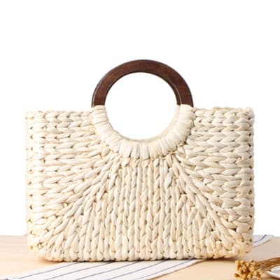 Structured hand woven rattan beach bag with a sturdy handle and outer pockets