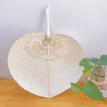 Cream heart shaped handwoven fan with a slim bamboo handle