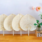 Cream heart shaped handwoven fan with a slim bamboo handle
