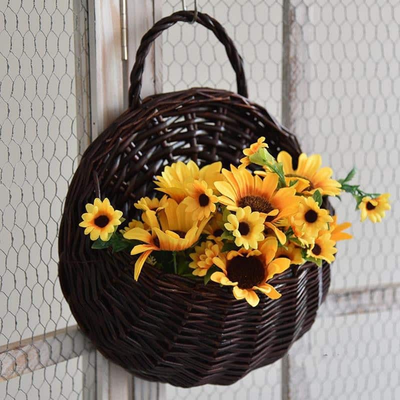 Two hanging rattan wall baskets filled with ivy