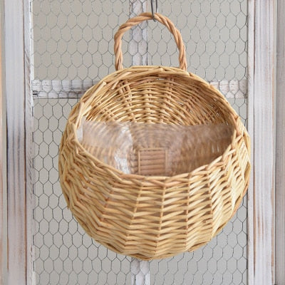 Two hanging rattan wall baskets filled with ivy