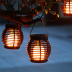 Small hanging hand woven rattan solar lantern with a handle