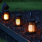 Small hanging hand woven rattan solar lantern with a handle