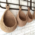 Teardrop woven wall baskets hanging on kitchen hooks