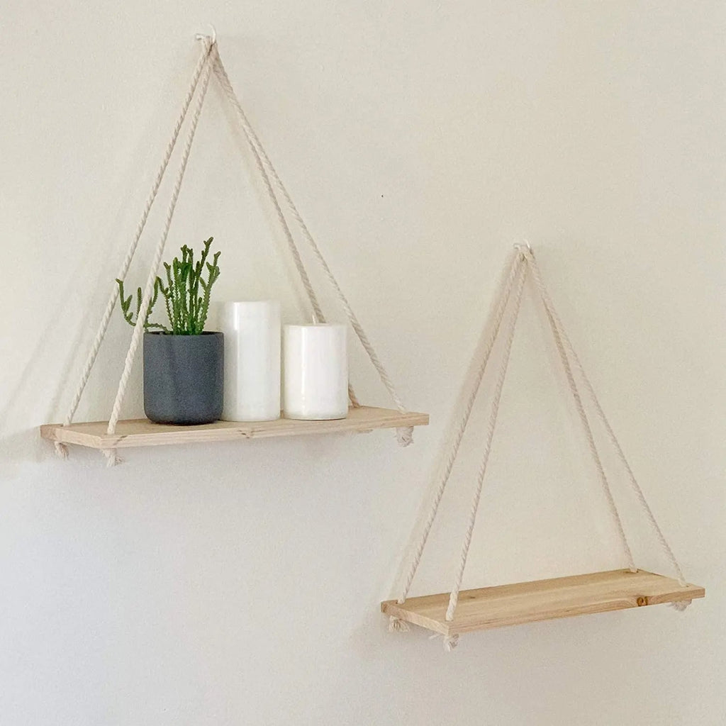 Natural wood shelf hung from a braided rope