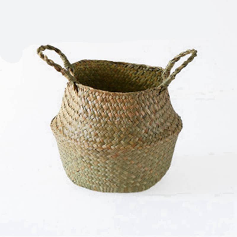 Three small woven belly baskets hanging on wall hooks with plants