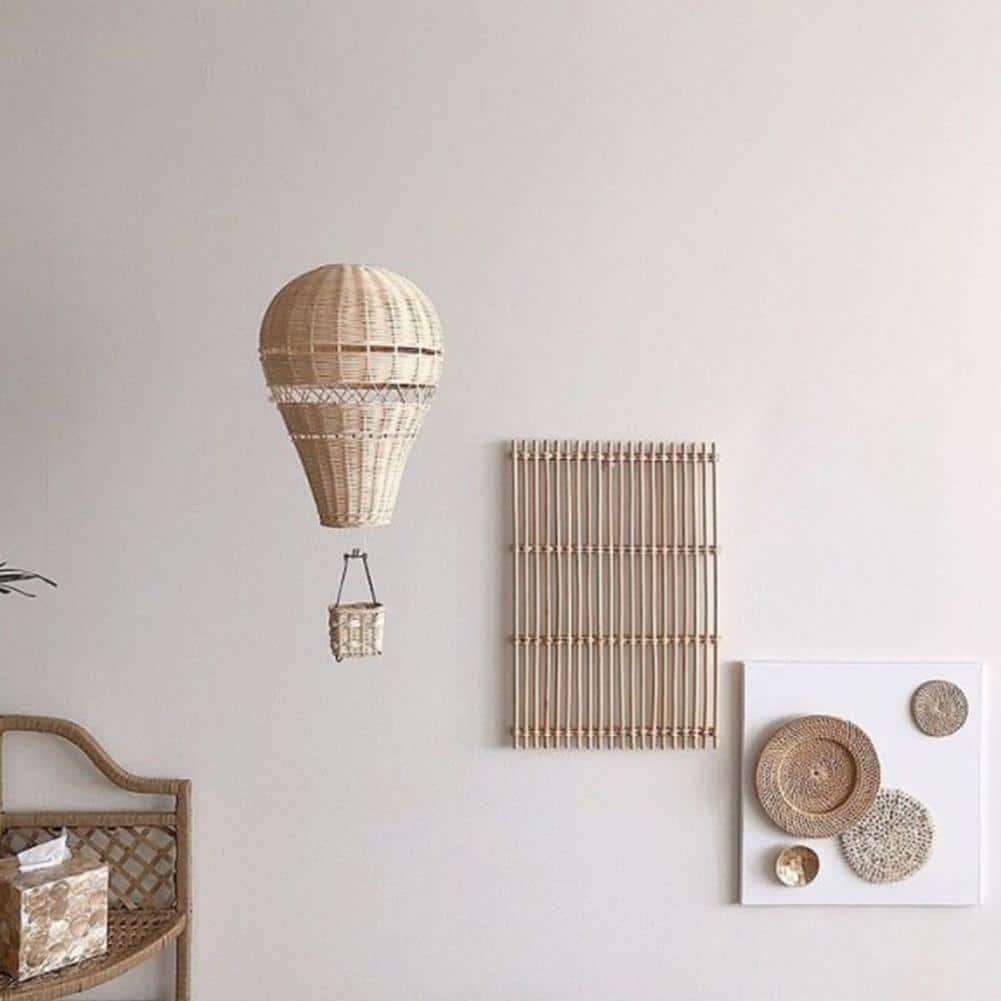 Hand woven rattan hot air balloon with a small basket hanging from the ceiling