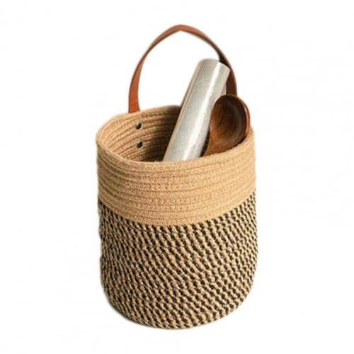 Round brown woven hanging basket with a leather strap