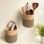 Round brown woven hanging basket with a leather strap