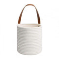 Round white woven hanging basket with a leather strap