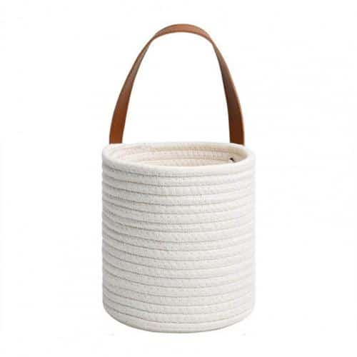 Round white woven hanging basket with a leather strap