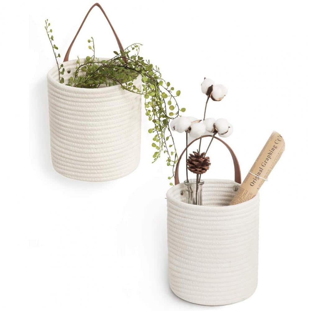 Round white woven hanging basket with a leather strap