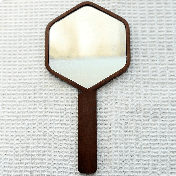 Hexagonal hand mirror with dark oak frame and long handle
