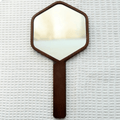Hexagonal hand mirror with dark oak frame and long handle