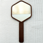 Hexagonal hand mirror with dark oak frame and long handle