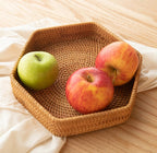 Hexagonal woven rattan tray holding apples