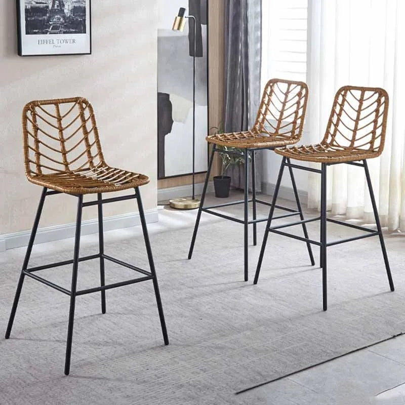 Tall bar chair with a hand woven rattan back and slim black metal legs