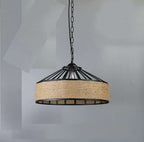 Industrial pendant light with a round black metal frame and a hand woven wicker shade hung by a chain