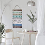 Hanging wood slat wall sign with positive quotes in soft colors