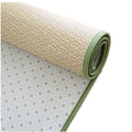 Rolled Japanese rattan mat with a green border and dotted non-slip backing