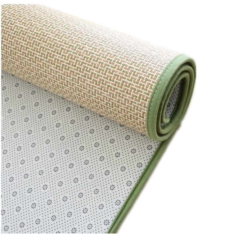 Rolled Japanese rattan mat with a green border and dotted non-slip backing