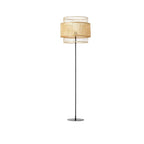 Japanese style floor lamp with a curved hand woven rattan shade and a dark metal stand