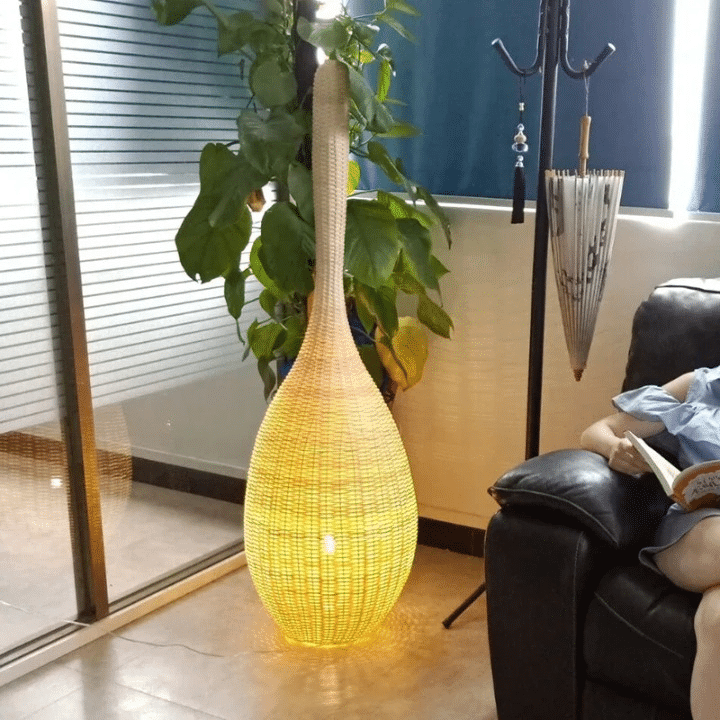 Japanese lantern style standing lamp with tight hand woven wicker slats on a wood base