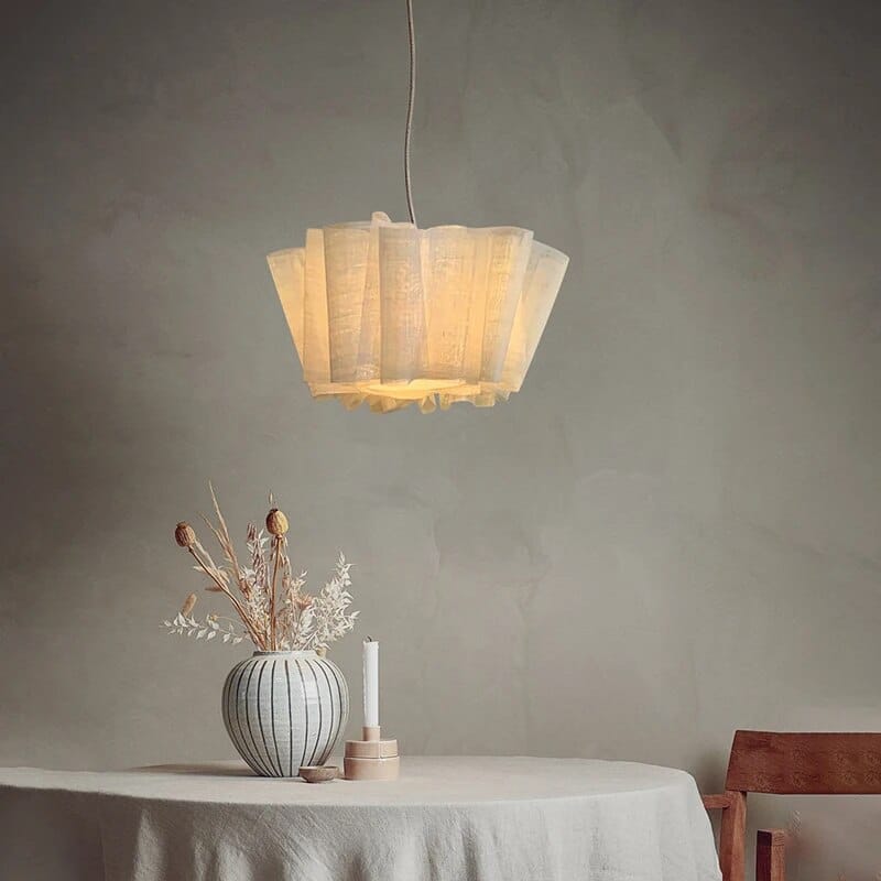 White pleated fabric pendant light above a table