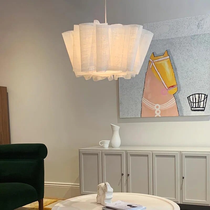 White pleated fabric pendant light above a table