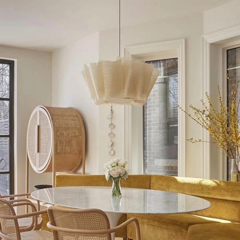 White pleated fabric pendant light above a table