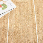 Rectangular jute rug with thin white border lines