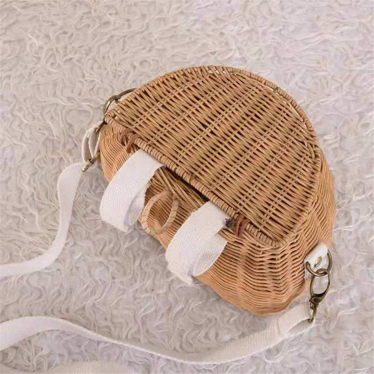 Small lidded wicker kids basket with a white strap