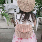 Small lidded wicker kids basket with a white strap