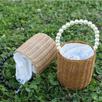 Small woven basket with bead handle and white drawstring liner