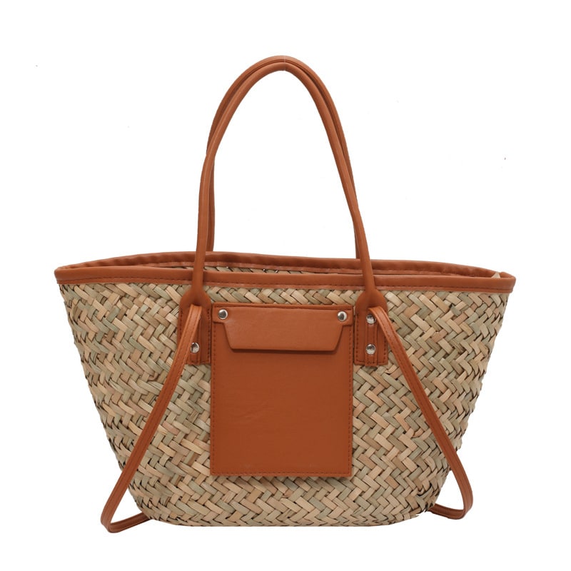 Large natural brown hand woven straw summer bag with two sturdy handles