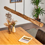 Large horizontal natural wood log pendant light on an iron structure