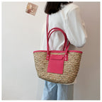 Large soft pink hand woven straw summer bag with two sturdy handles