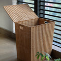 Large brown woven rattan trash can with a lid and two side handles