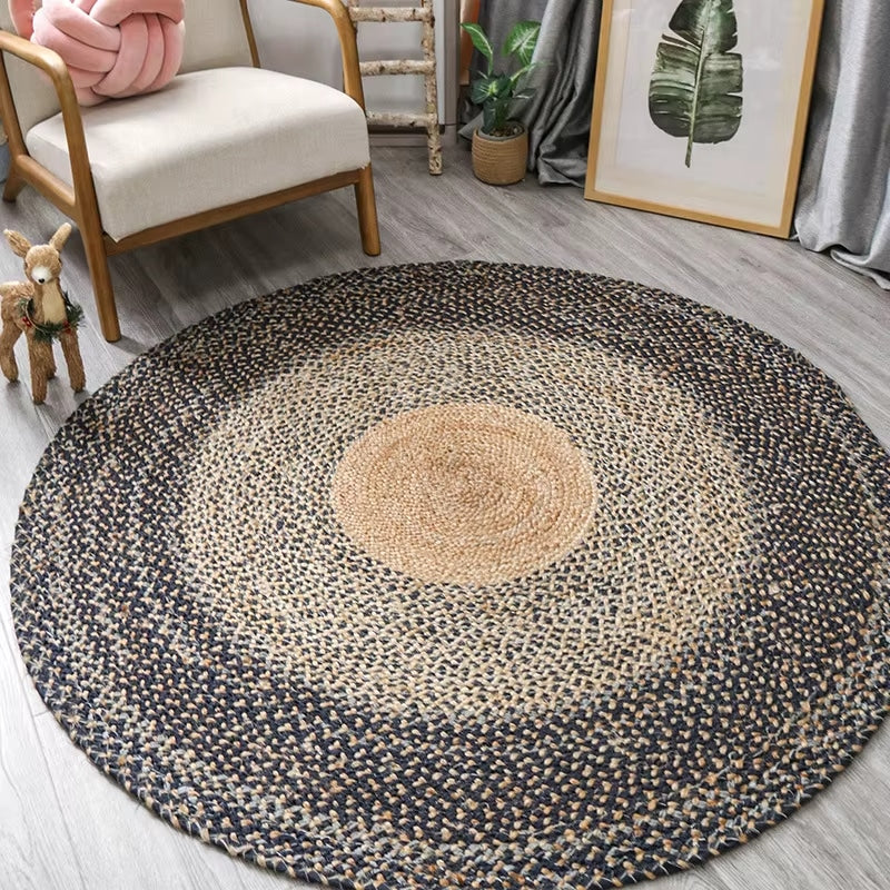 Large round braided rug with a natural center and dark blue gray rings