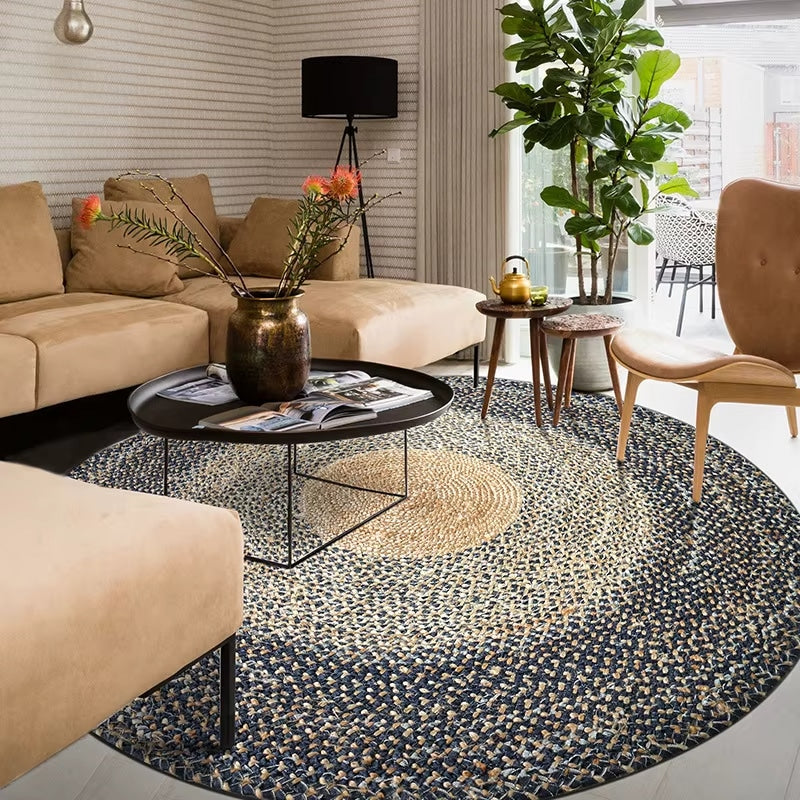 Large round braided rug with a natural center and dark blue gray rings