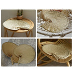 Large round woven fan on a bamboo frame, shown in a group on a console