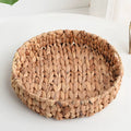 Large round handwoven rattan tray with raised edges