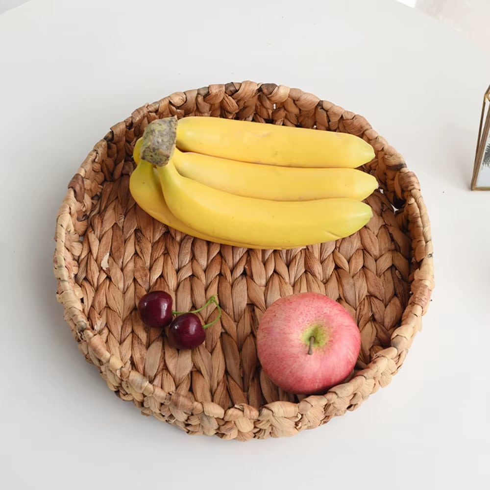 Large round handwoven rattan tray with raised edges