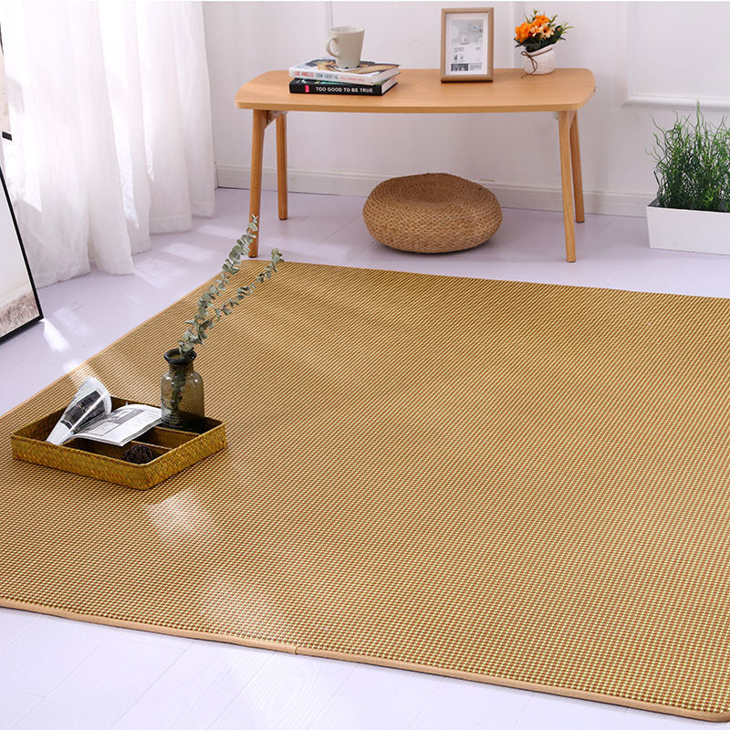 Large square woven rattan mat under a low table