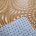 Large square woven rattan mat under a low table